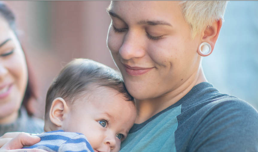 dad with short hair holding baby