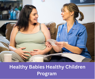 a pregnant woman sits with a health professional